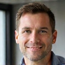 Portrait of Alex Johnson, CoreMen Founder, a smiling man with a thoughtful expression.